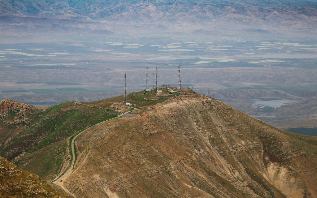 Telecommunications towers with mounted antennas against the sky